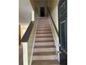 Carpeted staircase leading to the upper level of the home at 4752 Browns Mill Ferry Rd, Lithonia, GA 30038