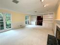 Bright living room with large windows, built-in shelving, and a fireplace at 5346 Light Cir, Norcross, GA 30071
