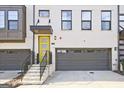 Townhome featuring a yellow front door, stone staircase, and an attached garage at 1149 Ansel Nw Ln, Atlanta, GA 30318