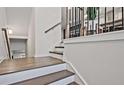 Staircase featuring modern black railings and beautiful wooden steps at 1149 Ansel Nw Ln, Atlanta, GA 30318
