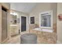 Well-lit bathroom with a tub, shower, vanity, neutral color palette, and tile flooring at 3735 Duckcove Way, Cumming, GA 30041