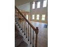 View of the foyer with a staircase featuring wood and iron railings, and light hardwood flooring at 1107 Kingston Hill Dr, Loganville, GA 30052