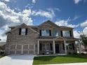 Beautiful two-story home featuring a brick facade, a two-car garage and covered front porch entrance at 1107 Kingston Hill Dr, Loganville, GA 30052