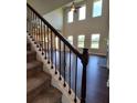Inviting living room featuring soaring ceilings, hardwood floors, and large windows for natural light at 1107 Kingston Hill Dr, Loganville, GA 30052