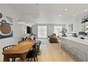 Open-concept living area with a modern dining table, stylish bar, and comfortable seating by the window at 560 Dutch Vly # 2313, Atlanta, GA 30324