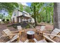 Beautiful backyard with a fire pit and outdoor seating area with wood pergola for entertaining at 6520 Glen Pond Trce, Cumming, GA 30028