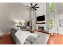 Bright living room with fireplace, vaulted ceilings, large windows, and comfortable seating at 6520 Glen Pond Trce, Cumming, GA 30028