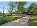 Inviting brick home with a covered carport and a neatly maintained front yard and long driveway at 264 Rockin Hill Dr, Marietta, GA 30060