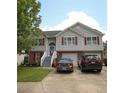 Inviting two-story home showcases a well-manicured lawn, neutral siding, brick facade and red shutters, with a two-car garage at 116 Remington Place Blvd, Dallas, GA 30157