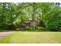 Charming home nestled among lush trees with a two-car garage and inviting front yard at 2261 Ravenwood Trl, Marietta, GA 30066