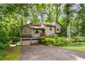 Charming home nestled among lush trees with a two-car garage and inviting front yard at 2261 Ravenwood Trl, Marietta, GA 30066
