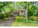 View of the home's exterior showcasing its mature landscaping and two-car garage at 2261 Ravenwood Trl, Marietta, GA 30066