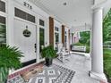Covered porch featuring a rocking chair, decorative rug, and potted plants enhance the home's inviting curb appeal at 275 Frances Rd, Canton, GA 30114