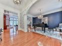 Elegant living room with hardwood floors, chandelier, and piano offers a sophisticated space for entertaining guests at 275 Frances Rd, Canton, GA 30114