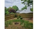 Backyard has wooden fence with landscaping near the house at 5859 Bellingrath Way, Lithonia, GA 30058
