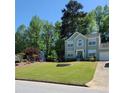 Charming two-story home with manicured lawn, neat landscaping, and attached garage at 5859 Bellingrath Way, Lithonia, GA 30058