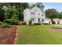 Lovely two-story home with green lawn, mature trees, and attached two-car garage at 5859 Bellingrath Way, Lithonia, GA 30058