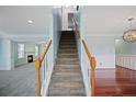Welcoming entryway with staircase, hardwood and carpeted flooring, and elegant lighting at 5859 Bellingrath Way, Lithonia, GA 30058