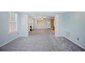 Spacious living room featuring carpet flooring, fireplace, and stylish columns at 5859 Bellingrath Way, Lithonia, GA 30058
