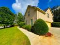 Well-maintained home with a three car garage, professional landscaping, and a side lawn at 842 Treeline Dr, Conyers, GA 30016