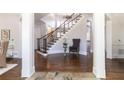 Grand foyer with hardwood floors, elegant staircase, decorative columns and natural light at 120 Kettering Trce, Tyrone, GA 30290