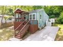 Charming blue home with a cozy front porch and wooden stairs leading to the entrance at 1482 Andrews Nw St, Atlanta, GA 30314