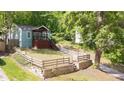 Landscaped front yard with a charming blue home, fenced yard, and inviting curb appeal at 1482 Andrews Nw St, Atlanta, GA 30314