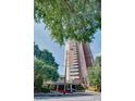 High rise condominium with red brick facade, canopy covered entrance, and lush greenery at 375 Ralph Mcgill Ne Blvd # 1701, Atlanta, GA 30312