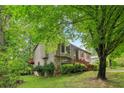 Lovely two-story home with stone accents, bay window, and lush green surroundings at 497 Fire Fly Dr, Tucker, GA 30084