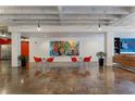 The open lounge area offers seating and a colorful mural as a focal point in the modern space at 878 Peachtree St # 601, Atlanta, GA 30309
