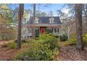 Front exterior of home featuring dormer windows, bright red front door, and a covered porch at 1645 Four Notch Rd, Carrollton, GA 30116
