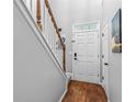 Welcoming foyer with hardwood floors and staircase offers a view of the bright front door at 2865 Winter Rose Ct, Dunwoody, GA 30360