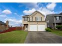 Inviting two-story home with a two-car garage, well-maintained lawn, and an ample driveway at 4015 Arch Pass, Cumming, GA 30040