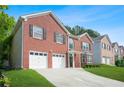 Attractive brick home with a well-maintained lawn, double garage, and inviting entrance in a residential area at 4125 Fallbrook Dr, Duluth, GA 30096