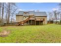 Expansive backyard featuring a two-story deck, backing up to a line of tall trees at 118 Hunters Pl, Villa Rica, GA 30180