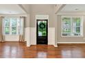 Bright foyer with hardwood floors, black front door, and plenty of natural light at 134 Johnston Farm Ln, Woodstock, GA 30188