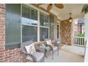 Inviting front porch with chairs and table; perfect for relaxing outdoors at 134 Johnston Farm Ln, Woodstock, GA 30188