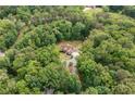 Panoramic aerial view of property surrounded by lush, mature trees at 1825 Epperson Rd, Canton, GA 30115