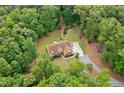 Aerial view of home surrounded by dense trees, nestled in nature at 1825 Epperson Rd, Canton, GA 30115