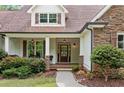 Close up image of the front porch with wood door and hanging lights at 1825 Epperson Rd, Canton, GA 30115