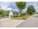 View of the side and front of this well maintained home in a desirable location with mature trees at 2180 Oakpointe Ct, Buford, GA 30519