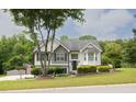 Beautiful home with green lawn, shrubbery, brick accents and a mix of vinyl and brick exterior at 2180 Oakpointe Ct, Buford, GA 30519