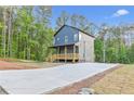 This is a two-story home with a welcoming front porch and a spacious driveway at 70 Wheeler Lake Path, Dallas, GA 30157