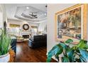 Bright living room with tray ceiling, hardwood floors, fireplace, and ample seating at 2191 Flowering Dr, Grayson, GA 30017
