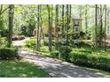 Lovely two-story home featuring a circular driveway and lush landscaping at 386 Collegiate Dr, Powder Springs, GA 30127