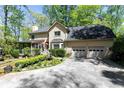 Charming home with a two-car garage, screened porch, and manicured garden at 386 Collegiate Dr, Powder Springs, GA 30127