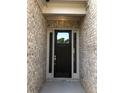 Inviting entryway featuring a stylish front door with sidelights and brick surround at 3925 Sierra Knolls Ct, Cumming, GA 30040