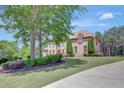 Beautiful two-story brick home with manicured lawn and professional landscaping at 105 New Castle Ln, Tyrone, GA 30290