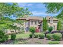 Stunning brick home with lush landscaping, mature trees, and circular driveway at 105 New Castle Ln, Tyrone, GA 30290