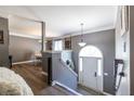 Home entryway with a staircase leading to the upper level and open view of the dining area with stylish decor at 1215 Smoke Hill Ln, Hoschton, GA 30548